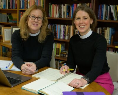 Katherine Frederick and Karen Freeman posing at work table
